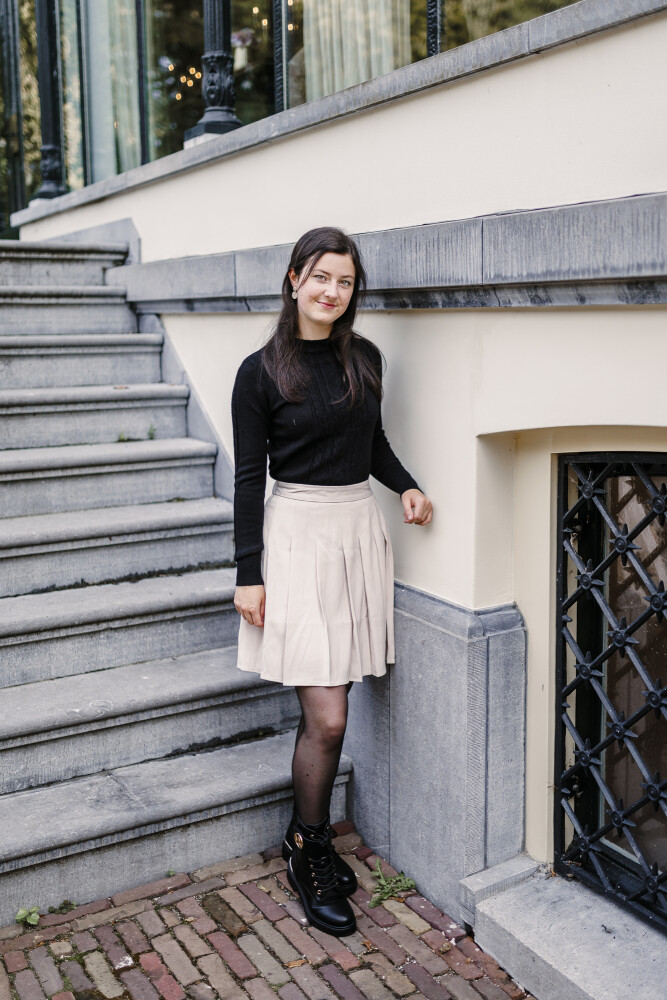 gevoerd rokje plooi zand en kabeltruitje zwart staan